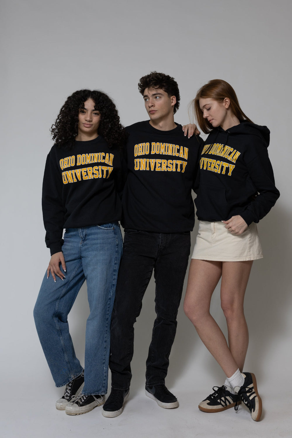 Three individuals wearing black hoodies with 'Ohio Dominican University' text on a plain background