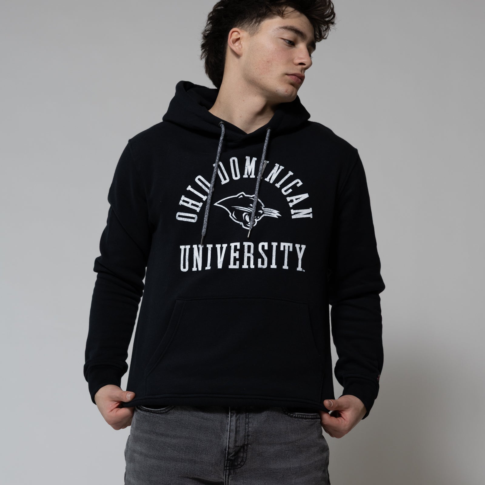 Person wearing a black hoodie with 'Old Dominion University' text on a plain background