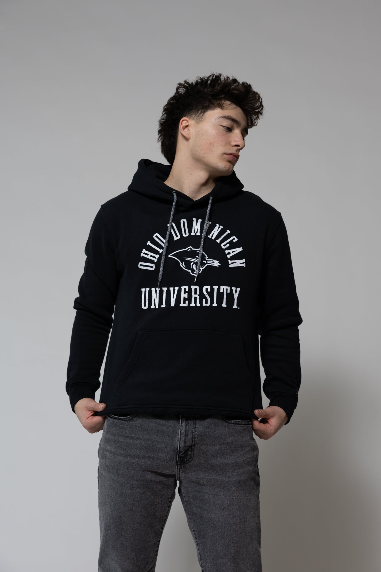 Person wearing a black hoodie with 'Old Dominion University' text on a plain background